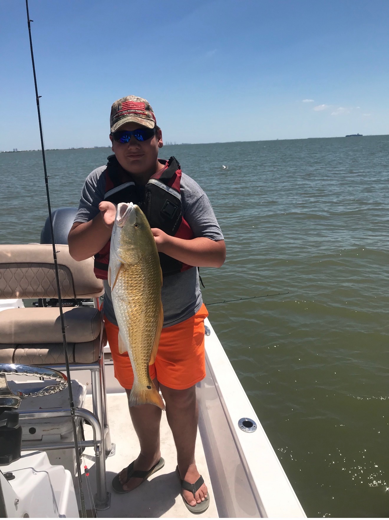 Youth angler with his first redfish on a Galveston family fishing trip